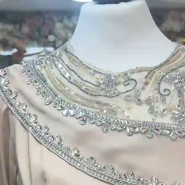 Crystal-beaded bodice of a modest gown